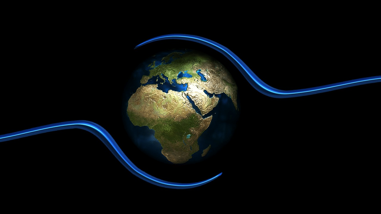 Image of planet earth between two hands-like lines